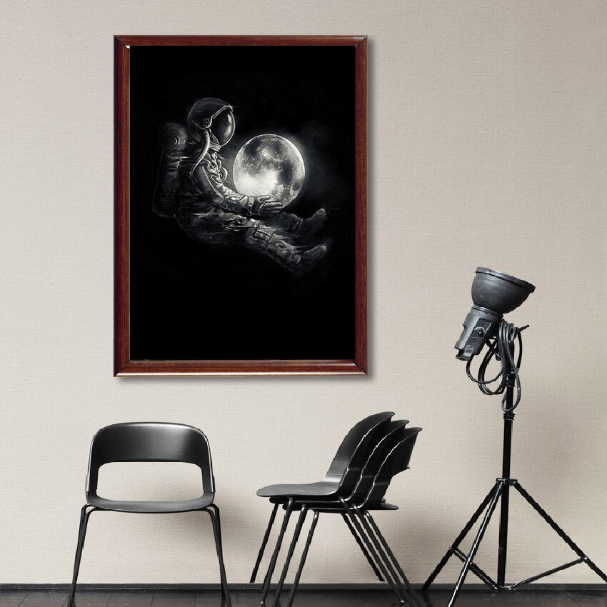 Astronaut Holding Moon Canvas Art