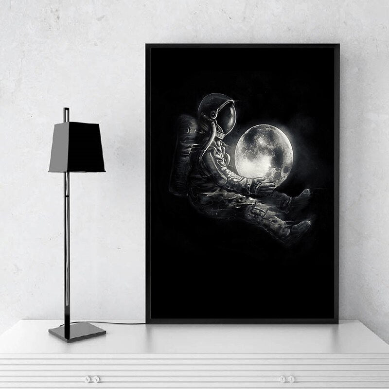 Astronaut Holding Moon Canvas Art